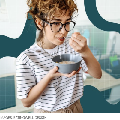 Woman with glasses and striped shirt eating bowl of cereal standing