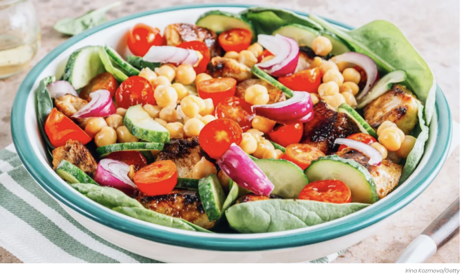 Bowl with salad, beans, chicken, cucumbers, tomatoes