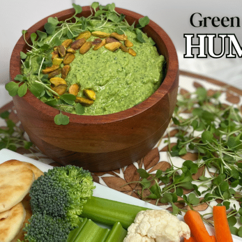 Green goddess hummus feature image with hummus in wood bowl on tray with dipping options like bread and raw veggies
