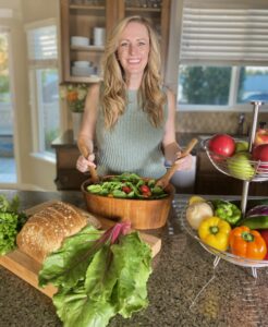 Sheila with colorful salad and produce