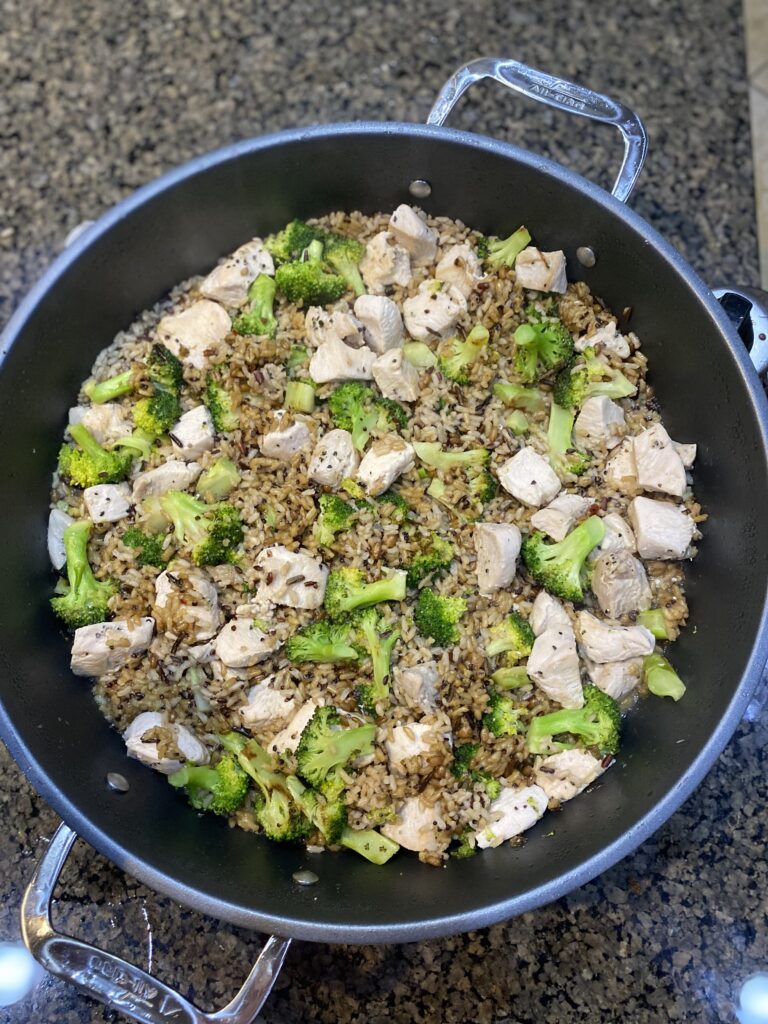 chicken and grain bowl cooked ingredients mixed in electric grill pan before serving