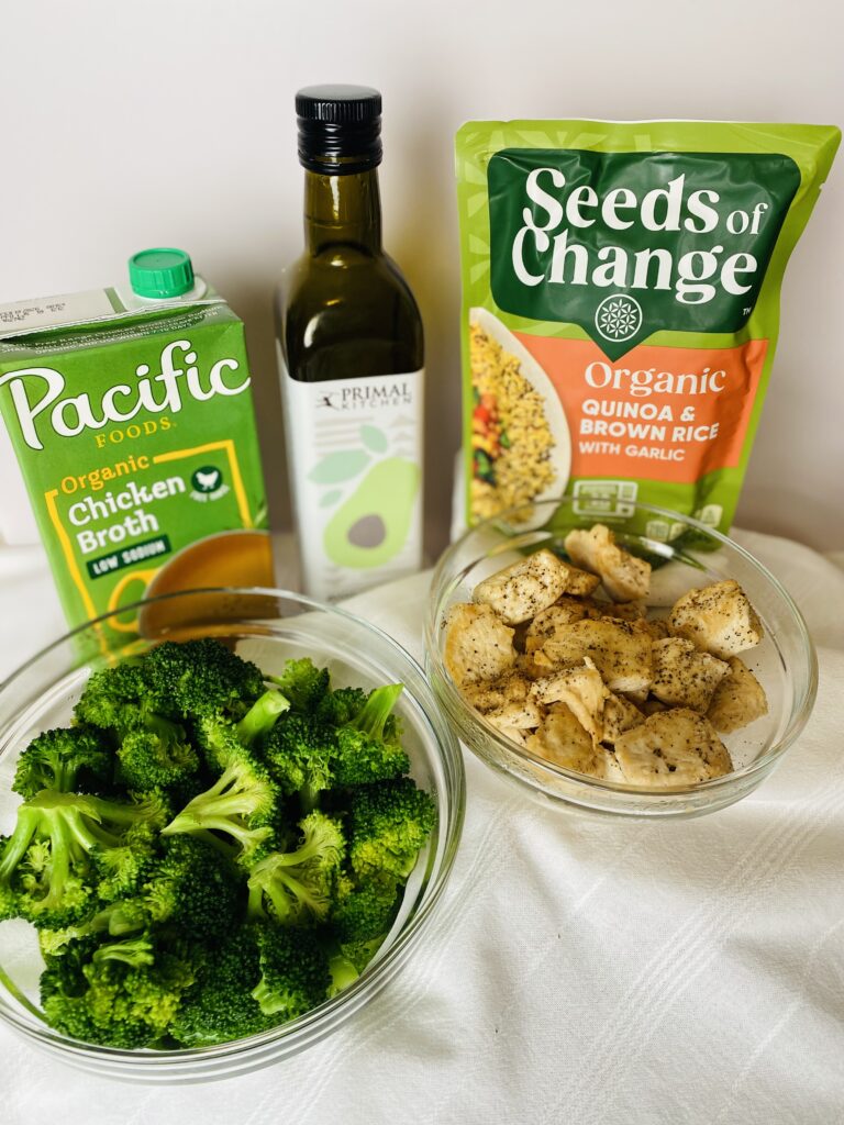 individual ingredients for chicken grain bowl including chicken. broccoli, seeds of change quinoa packet and olive oil