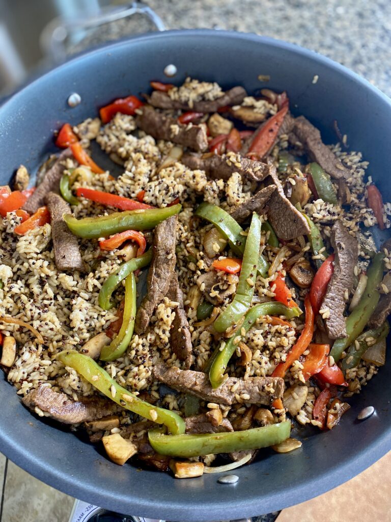 veggies cooking with fajita steak strips