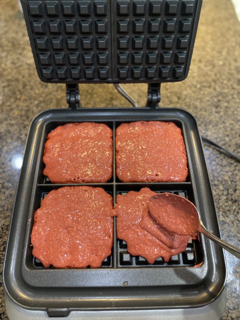 waffle batter in 4 section waffle iron