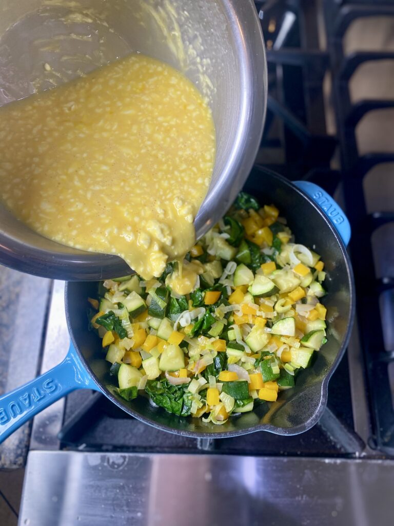 Pouring Eggs Into Veggies 